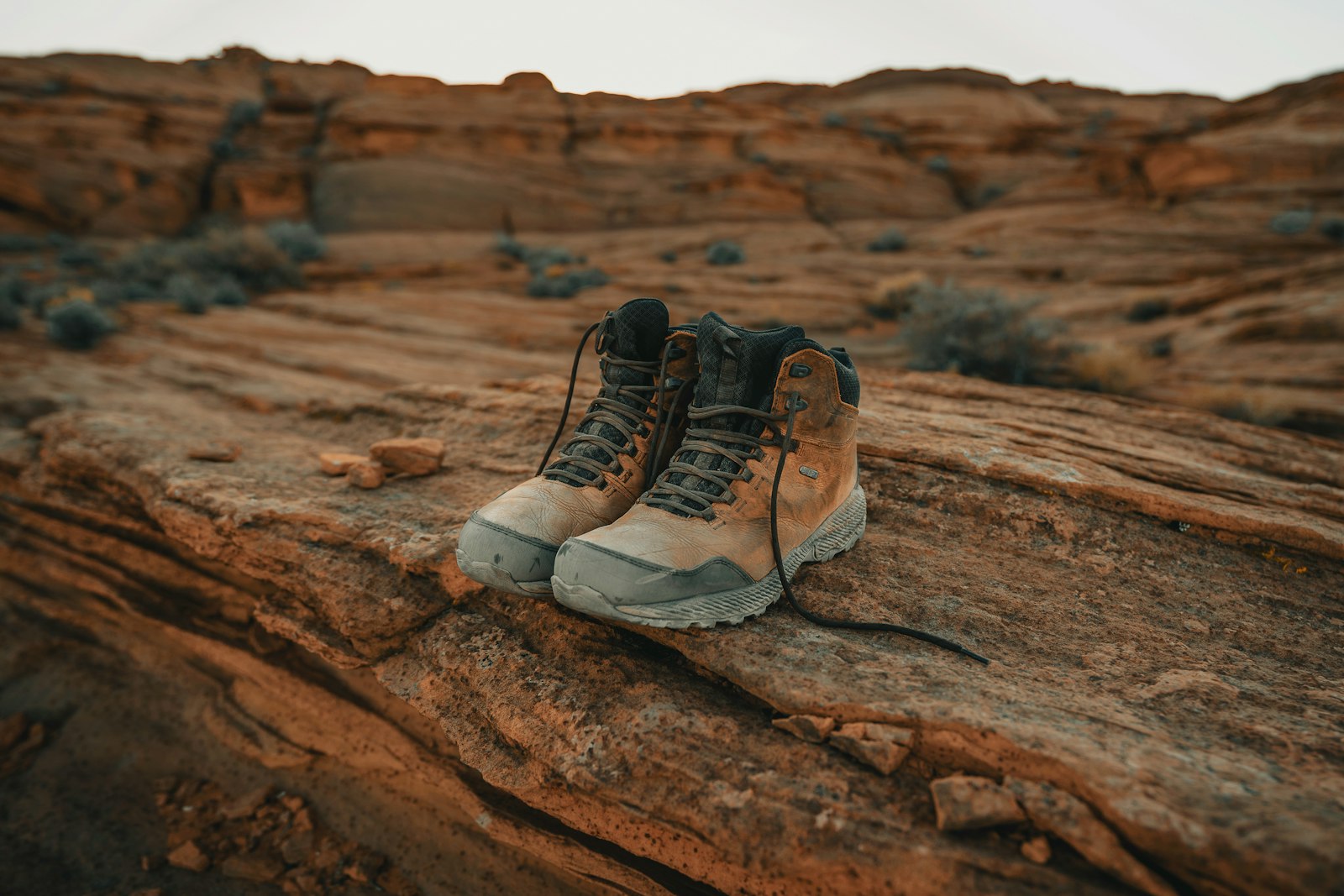 Close-up of hiking boots on a trail, the ankle-level area gaiters are designed to protect
